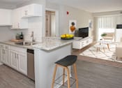 Thumbnail 1 of 20 - Full Kitchen with Island Open to Furnished Living Room