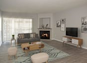 Thumbnail 4 of 20 - Furnished Living Room with Fireplace and Sliding Glass Door