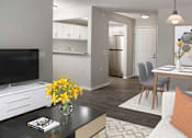 Thumbnail 5 of 20 - a living room and dining room with a table and a television