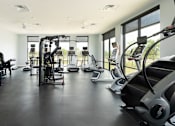 Thumbnail 18 of 40 - Fitness center with treadmills, stair master and weight machines.