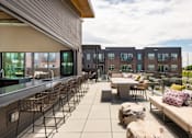 Thumbnail 22 of 40 - Clubhouse with Outdoor Lounge Area
