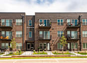 Thumbnail 40 of 40 - Apartment building with balconies and black railings.