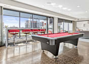 Thumbnail 30 of 40 - a pool table in a living room with a view of the city