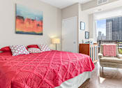 Thumbnail 16 of 40 - a bedroom with a red bed and a large window