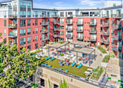 Thumbnail 18 of 40 - an aerial view of an apartment complex with people in a courtyard