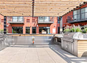 Thumbnail 31 of 40 - an outdoor kitchen with stainless steel appliances and a wooden canopy