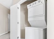 Thumbnail 15 of 40 - an empty laundry room with a washer and dryer in it