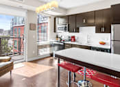 Thumbnail 9 of 40 - a kitchen with a large island and a balcony