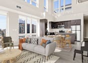 Thumbnail 5 of 40 - a living room with a couch and a table and a kitchen with a large window