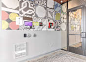 Thumbnail 17 of 40 - a mural on the wall of a building with a glass door