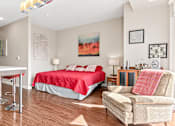 Thumbnail 13 of 40 - a bedroom with a red bed and a desk and a chair