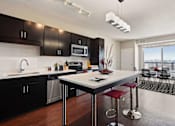 Thumbnail 1 of 40 - Bright and spacious kitchen with stainless steel appliances, pendant lighting above the island, and gorgeous view of the dining area.
