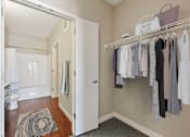 Thumbnail 14 of 40 - Large walk in closet with shelf storage and doors leading into the private master bathroom.
