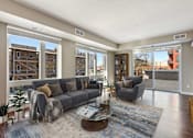 Thumbnail 2 of 40 - Open living spaces with large windows and glass doors leading out to the private balcony or patio.