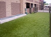 Thumbnail 24 of 40 - Outdoor dog park fenced in with building to the left.