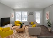 Thumbnail 4 of 28 - Bright and airy living space that leads out to your private patio or balcony. Living area has large window next to patio door as well.