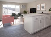 Thumbnail 9 of 28 - View from the kitchen of a studio unit leading into the living area.