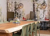Thumbnail 19 of 28 - a dining room with a wooden table and green chairs