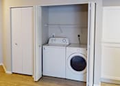 Thumbnail 12 of 28 - a white washer and dryer in a laundry room