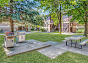 Thumbnail 12 of 17 - a picnic area with a grill and picnic table in front of a house