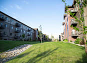 Thumbnail 15 of 18 - Exterior River Ridge Balconies and Green Lawn