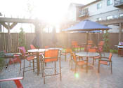 Thumbnail 14 of 18 - Outdoor Community Patio with Tables and Grill