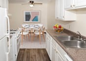 Thumbnail 4 of 23 - a kitchen and dining room with a table and chairs