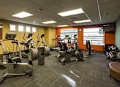 Thumbnail 12 of 18 - a gym with various exercise equipment in a building