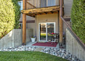 Thumbnail 13 of 20 - Private Patio with Rock Beds, Sliding Glass Door, and Path to Grass