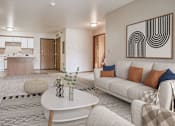 Thumbnail 4 of 20 - a living room with a couch and a table