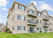 Thumbnail 6 of 14 - the view of an apartment building with balconies and a lawn