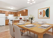 Thumbnail 2 of 14 - a dining room with a wooden table and chairs