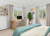 Thumbnail 8 of 14 - a bedroom with a bed and a desk with a computer