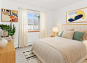 Thumbnail 7 of 14 - a bedroom with a bed and paintings on the wall