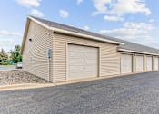Thumbnail 13 of 14 - a large garage with multiple doors on the side of a building