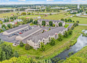 Thumbnail 14 of 14 - an aerial view of a building next to a body of water