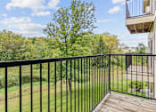 Thumbnail 3 of 14 - a balcony with a view of a yard and trees