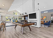 Thumbnail 18 of 34 - A billiard table is in the middle of a room with a television and a pool table.