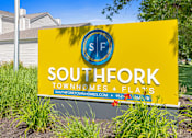 Thumbnail 34 of 34 - A yellow sign for Southfork Townhomes and Flats.
