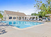 Thumbnail 13 of 34 - A large swimming pool with a building in the background.
