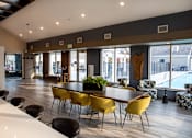 Thumbnail 18 of 29 - Community Clubhouse with Large Tables and Bar