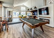 Thumbnail 17 of 29 - an open living room with a pool table and a tv