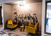 Thumbnail 21 of 29 - Lobby Nook with Chairs and Historic Mural on Wall