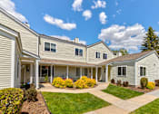 Thumbnail 1 of 29 - a group of houses with lawns and trees in front of them