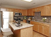 Thumbnail 7 of 34 - A kitchen with wooden cabinets and a marble countertop.