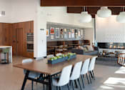 Thumbnail 4 of 28 - a dining room and living room with a table and chairs at The Bosk Apartment Homes, Woodbury, Minnesota