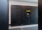 Thumbnail 25 of 28 - a row of lockers in a room with one door open at The Bosk Apartment Homes, Woodbury