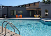 Thumbnail 5 of 28 - a swimming pool with a house in the background at The Bosk Apartment Homes, Minnesota