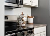 Thumbnail 2 of 28 - a kitchen with a stove and a refrigerator at The Bosk Apartment Homes, Woodbury, 55125
