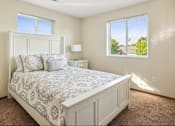 Thumbnail 6 of 29 - A bedroom with a large bed and a window overlooking a green landscape.
